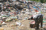 A scavenger collects reusable plastic from the illegal open dumpsite in Malapatan town in the southern Philippines. Image by Bong S. Sarmiento.